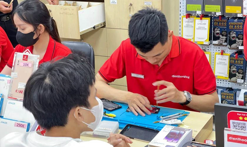 Kh&aacute;ch h&agrave;ng c&ugrave;ng kỹ thuật vi&ecirc;n tại cửa h&agrave;ng Điện Thoại Vui