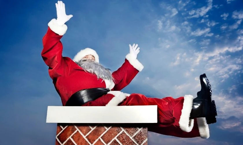 &Ocirc;ng gi&agrave; Noel chui v&agrave;o ống kh&oacute;i v&agrave;o Gi&aacute;ng Sinh